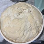 sourdough overfilling a bowl after doubling in size
