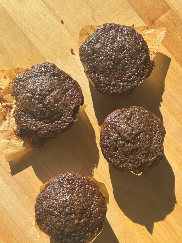 Chocolate Sourdough Muffins on a wooden cutting board