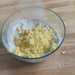 Adding grated butter to dry ingredient mixture
