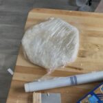 Pre-rolled sourdough pie crust wrapped in plastic wrap.