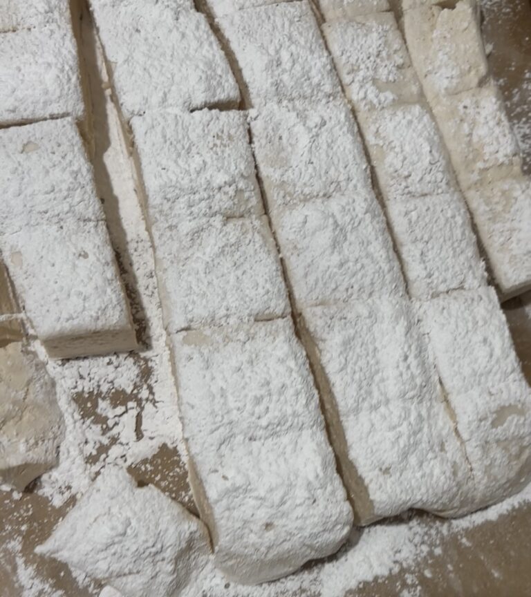 Homemade Marshmallows cut into squares, dusted with arrowroot powder on a parchment paper.